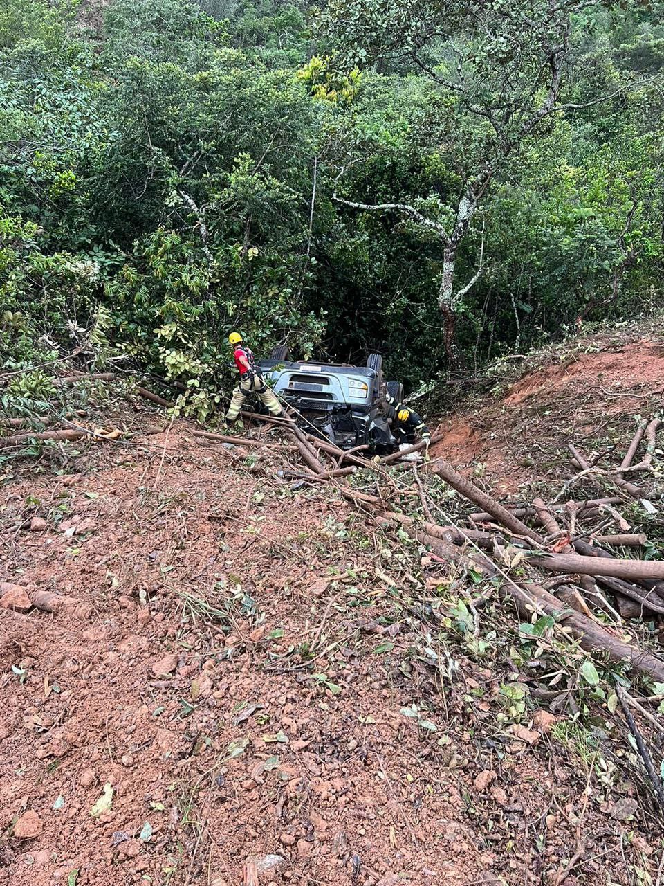 Motorista morre após carreta de eucalipto cair em ribanceira na MGC-451, em Diamantina - Foto: Divulgação/CBMMG