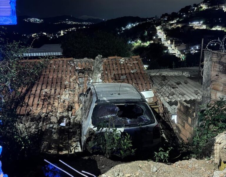 Carro bate em muro e fica pendurado sobre telhado de casa na Grande BH Carro bate em muro e fica pendurado sobre telhado de casa na Grande BH - Foto: Divulgação/CBMMG